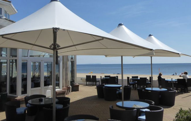 Vortex parasol providing cover for outdoor cafe area