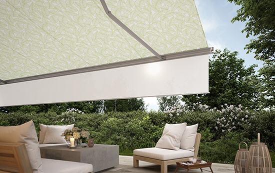 Retractable awning with drop down valance and green leaves fabric pattern