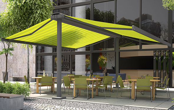 Green striped butterfly awning covering outdoor seating and dining area