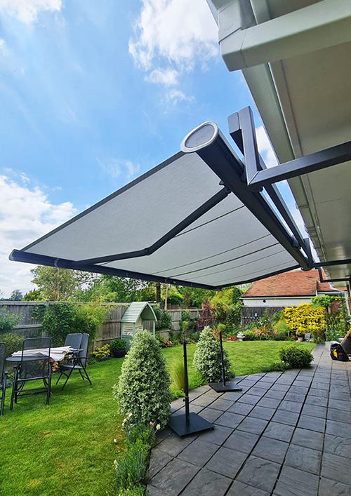Large, grey retractable awning for patio