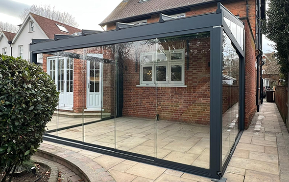 Glass Outdoor Room with Underglass Electric Awning and Sliding Glass Doors
