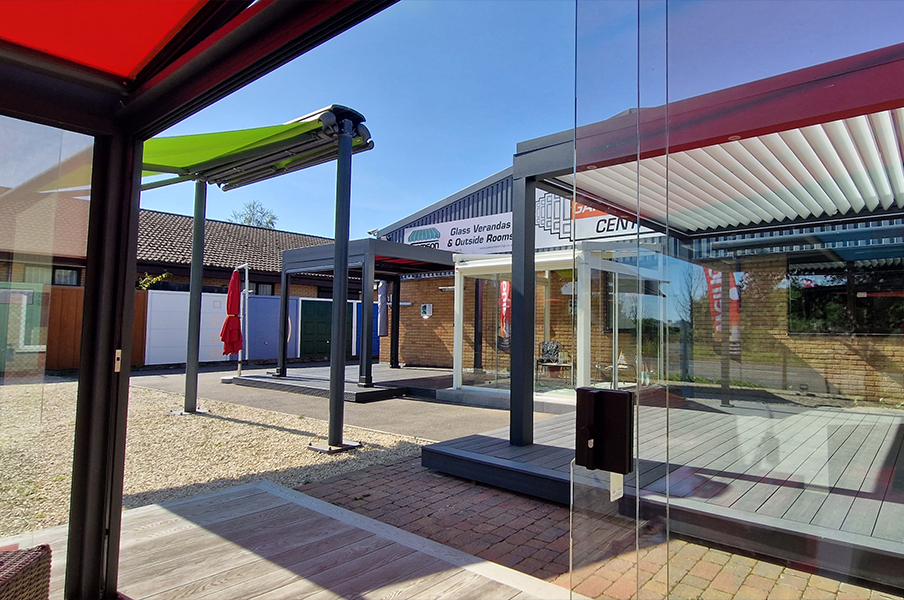Samson Outdoor Living outdoor showroom featuring glass room. butterfly awning, louvered roof systems